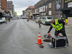 A technician on site of the Johannesburg gas explosion on Lillian Ngoyi Street, descending the elios 3 underground for visual inspection