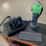 The VEO 3 alongside a keyboard on a working desk