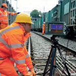 Two technicians operating the VEO 3 on a railway track