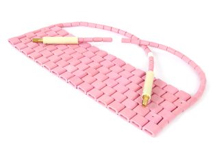 220 and 240 voltage pink ceramic pad heaters for heat treatment, placed on a white background